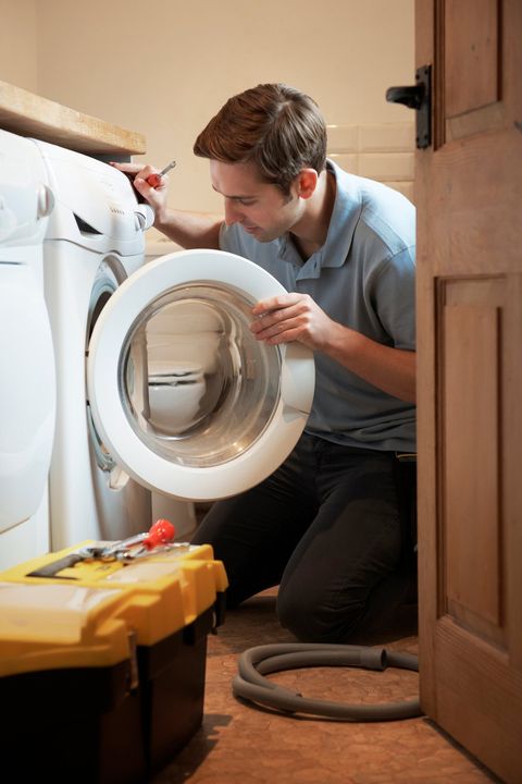 Repairman Fixing Washing Machine — Dyer, IN — Anderson Appliance Repair Repairman Fixing Washing Machine — Dyer, IN — Anderson Appliance Repair