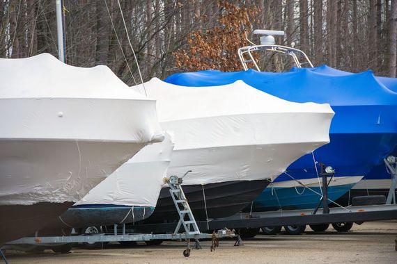 boats with tarpaulin stopped in the yard