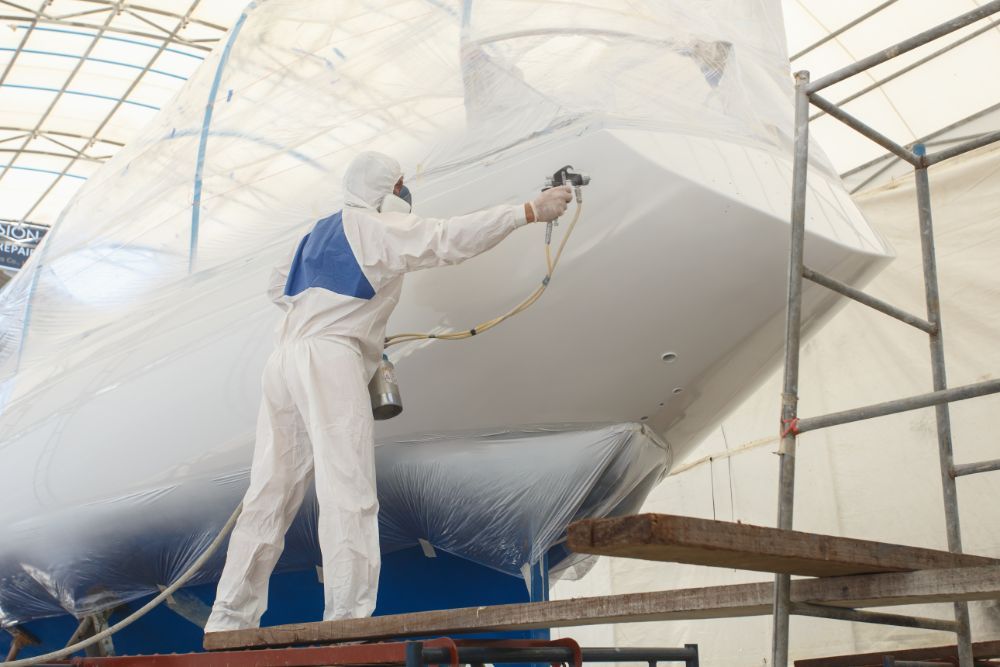 shipyard worker during the painting of a yacht
