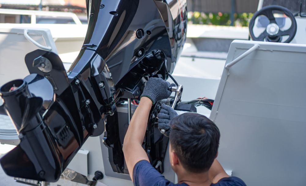 mechanic while repairing a boat engine