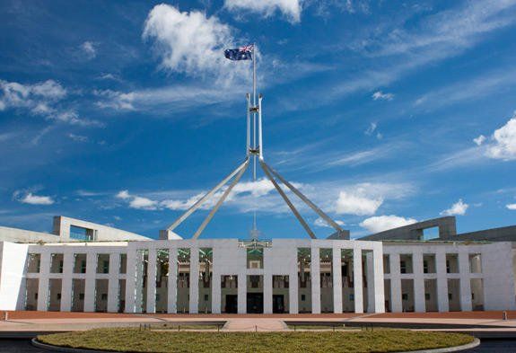 Australian Parliament House in Canberra, white building with flagpole under a blue sky