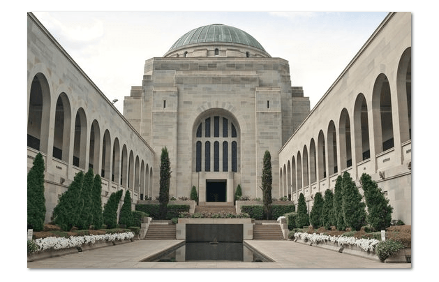 Courtyard of a grand stone building with arched colonnades and a domed central facade