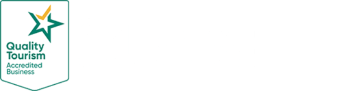 Quality Tourism Accredited business logo with a green and gold star on a white background