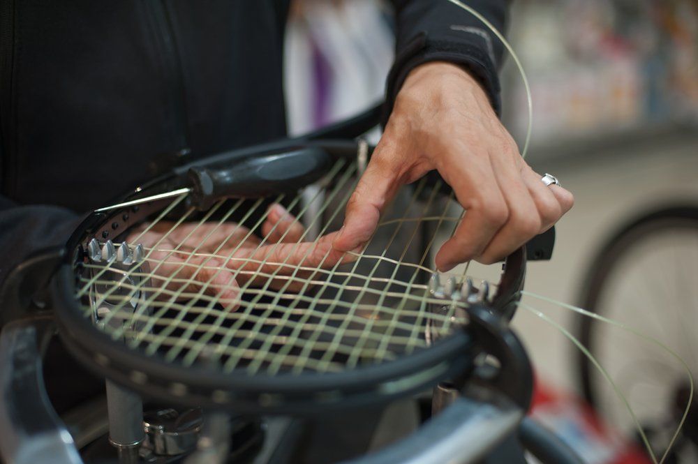 Support NETS by having your racket restrung Racket stringer at work