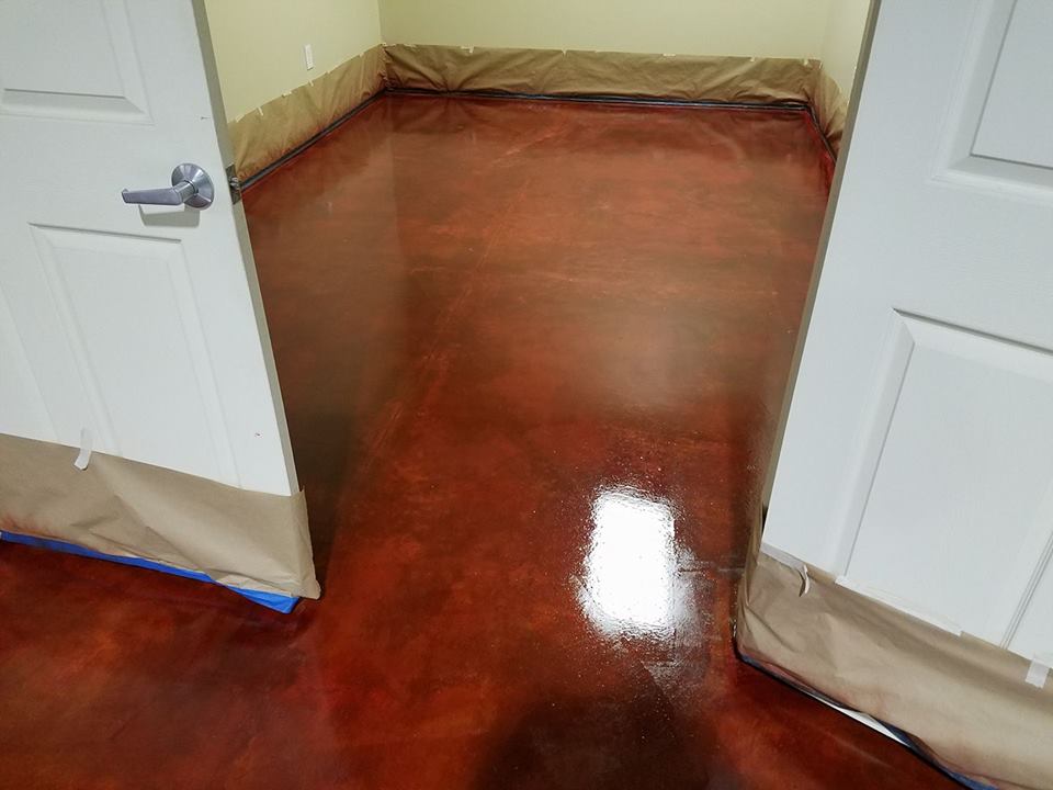 Partially opened white double doors revealing a glossy red-brown floor in a hallway