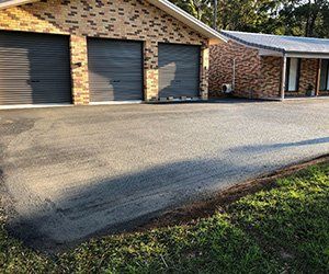 Freshly paved driveway — North Coast Asphalts in Corindi Beach, NSW Freshly paved driveway — North Coast Asphalts in Corindi Beach, NSW