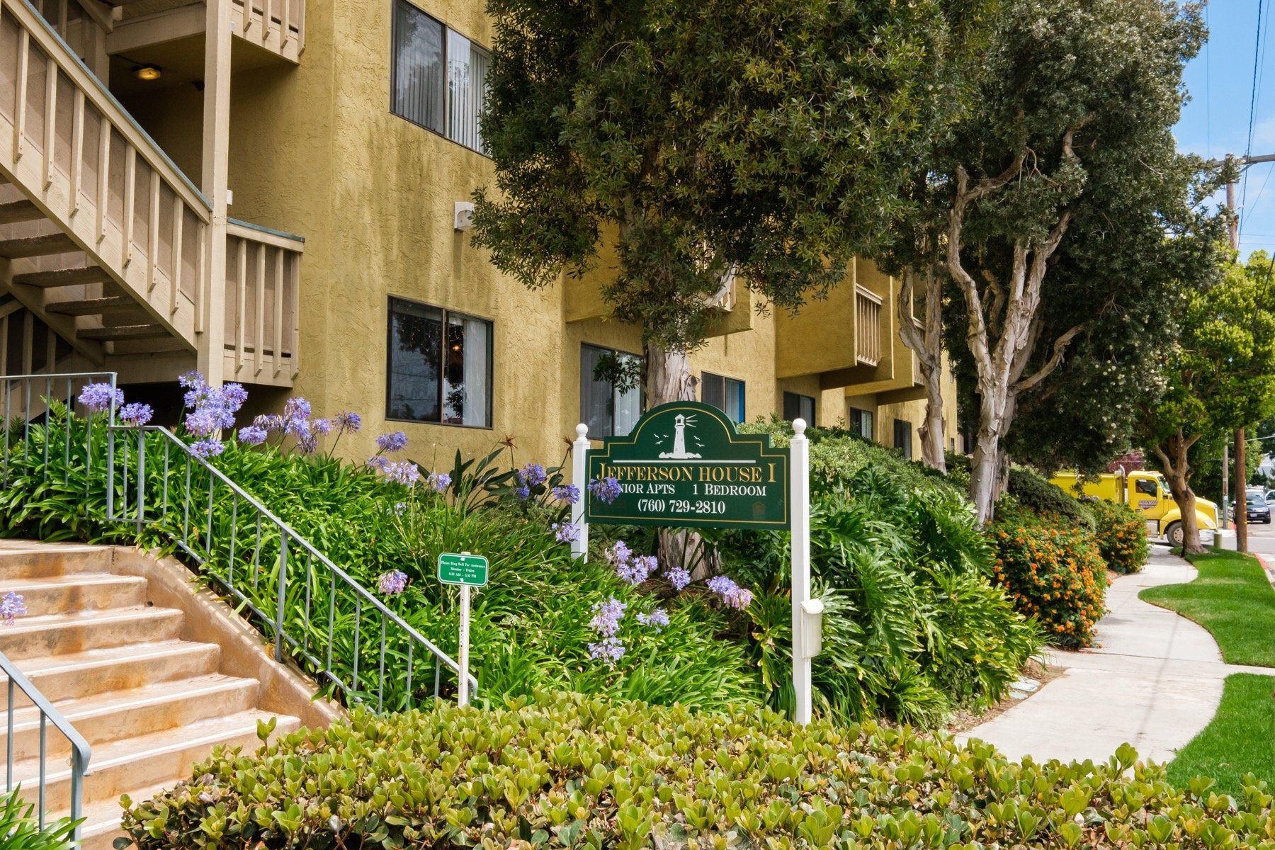 A building with stairs and a sign in front of it