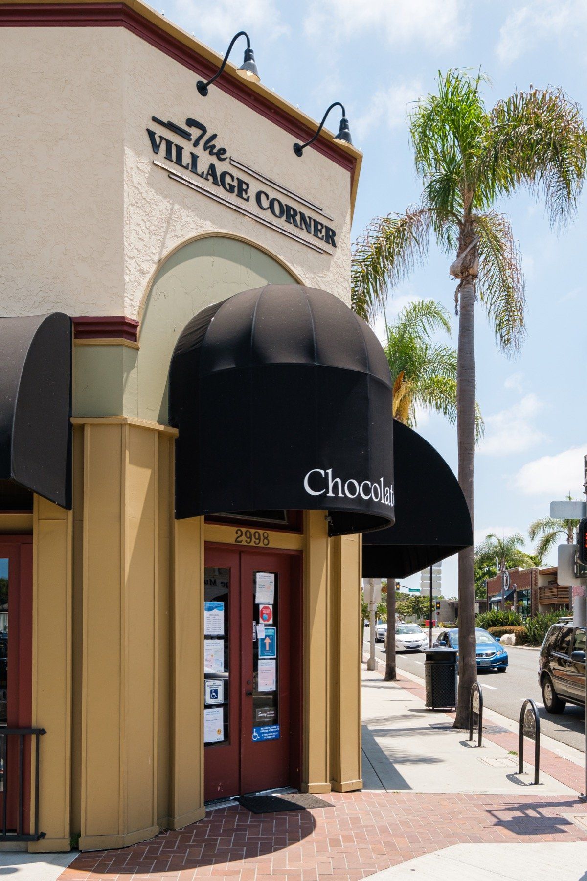 A building with a sign that says the village corner