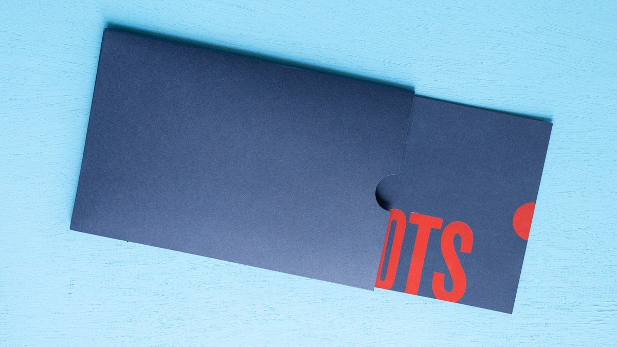 Dark blue card slides out of envelope, red 