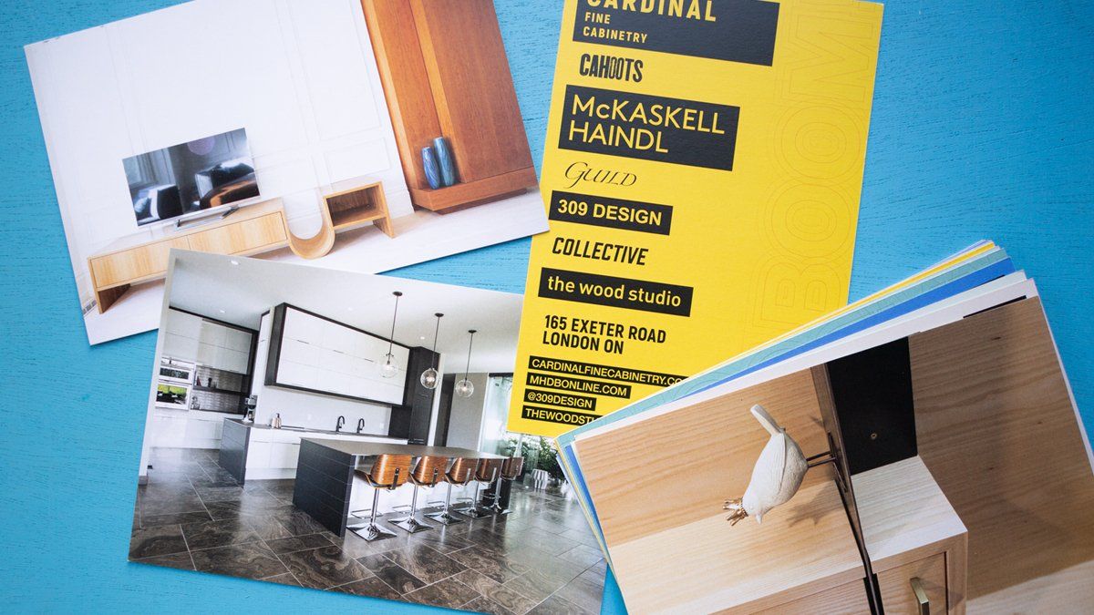 Photos of interior design and a yellow brochure on a blue surface.