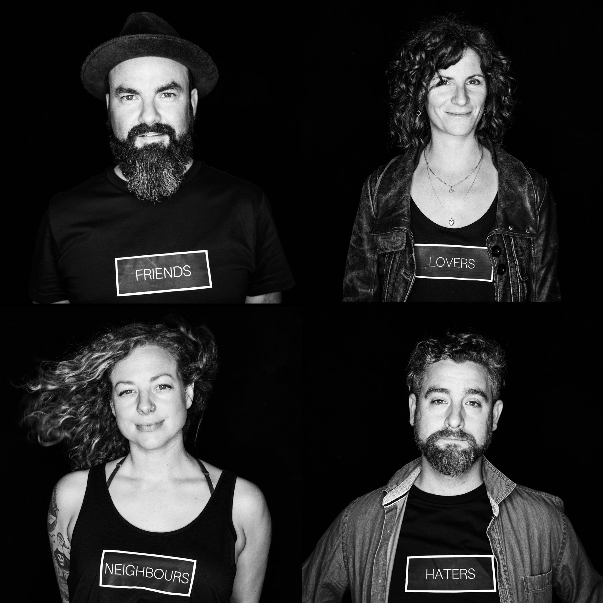 Four people wearing shirts labeled 