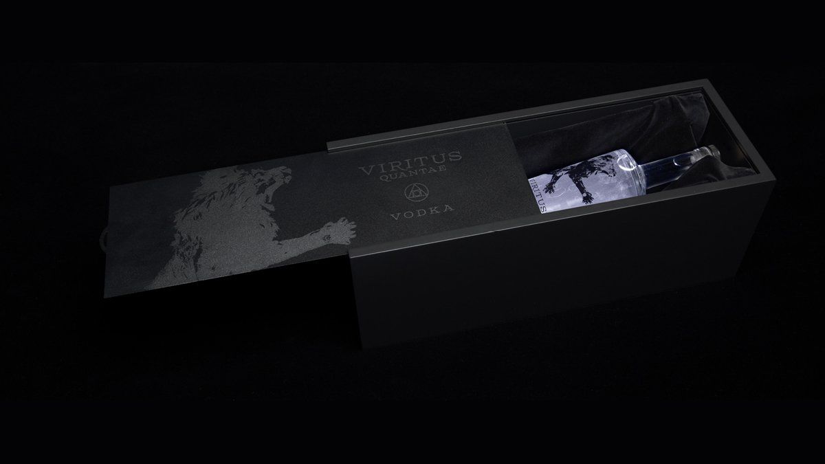 Black box partially open, revealing a bottle of wine. Dark background.