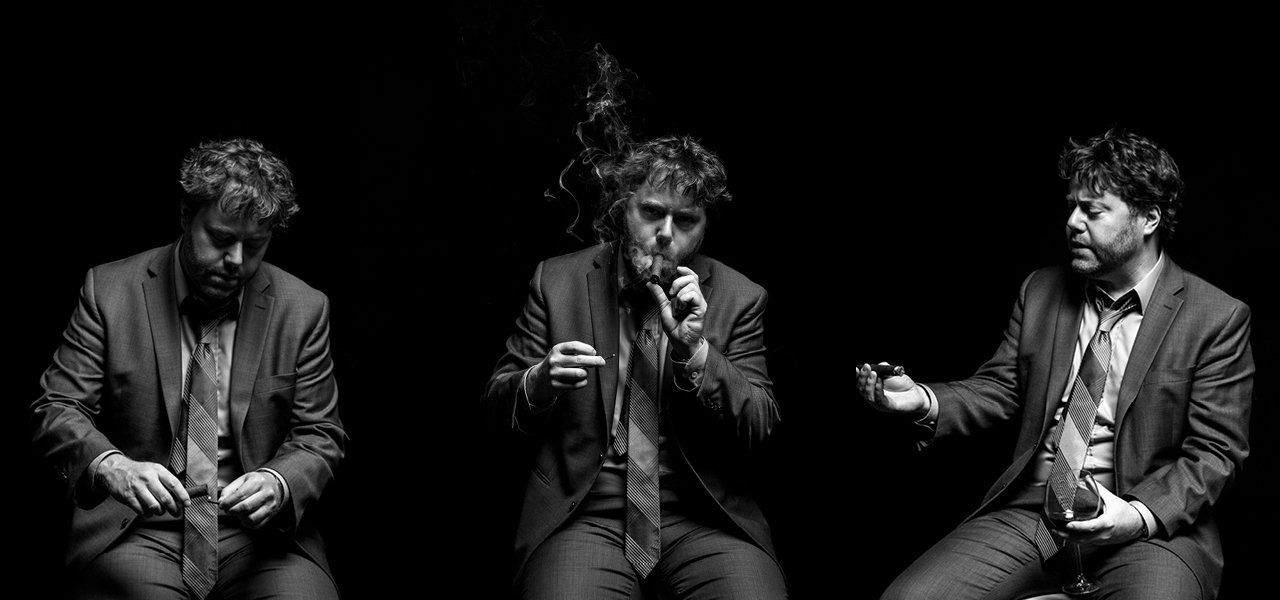 Three side-by-side shots of a person in a suit lighting a cigar, exhaling smoke, and gesturing. Black background.