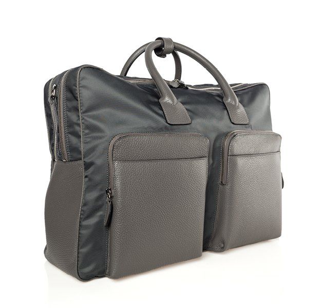 Gray travel bag with two front pockets, leather handles, and nylon body.