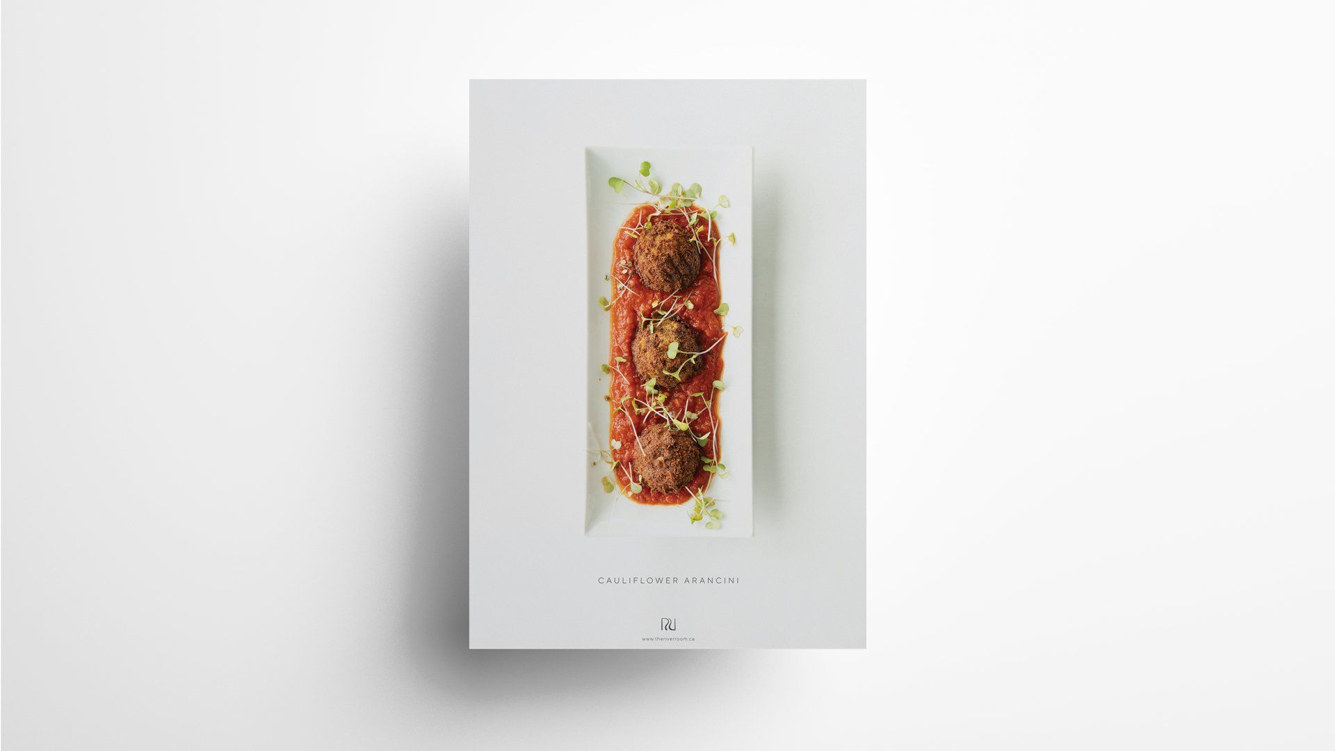 Meatballs in tomato sauce on a rectangular white plate, garnished with green herbs.