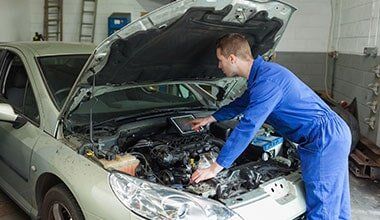 Mechanic Checking Engine - Automotive in Skowhegan, ME Mechanic Checking Engine - Automotive in Skowhegan, ME