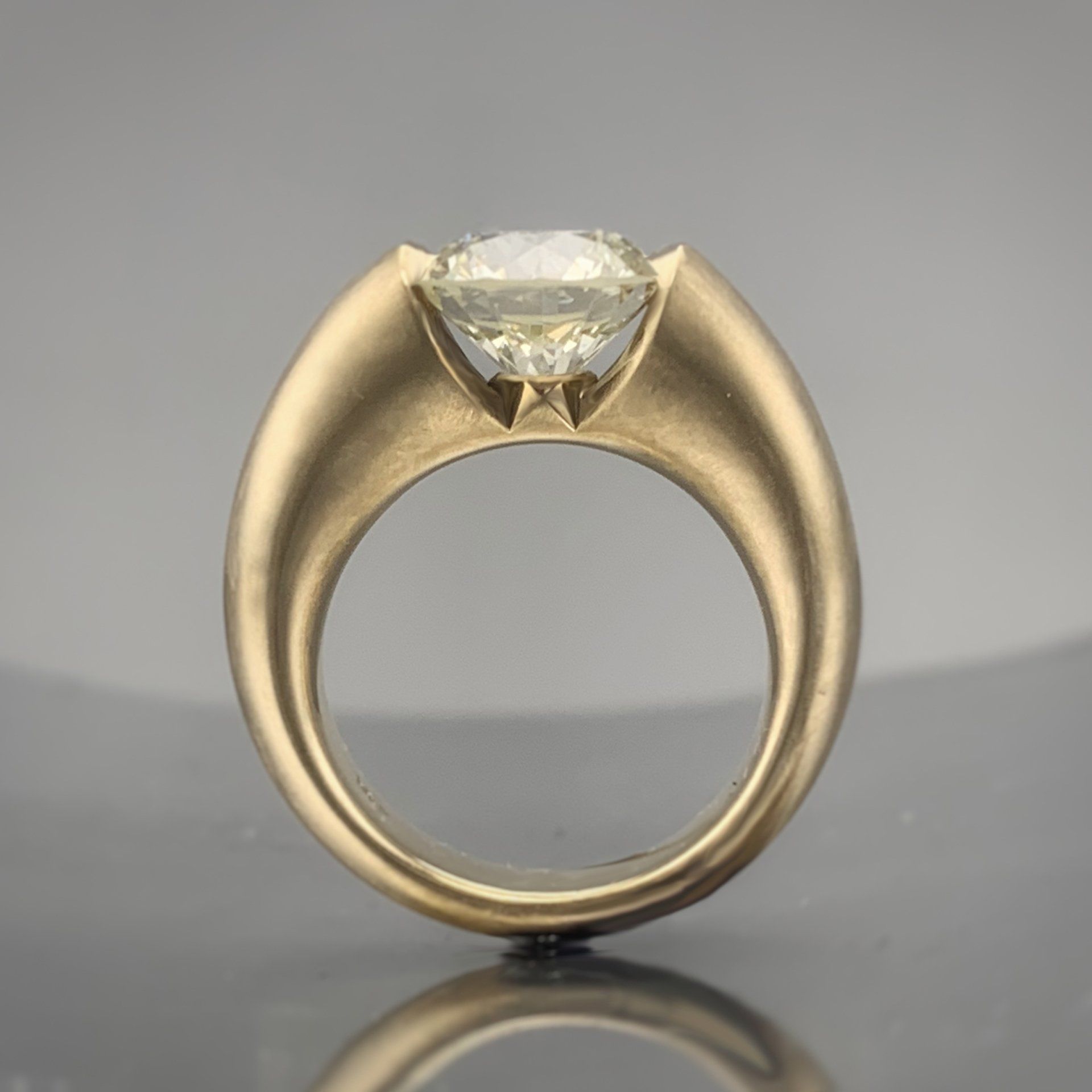 A gold ring with a diamond in the center