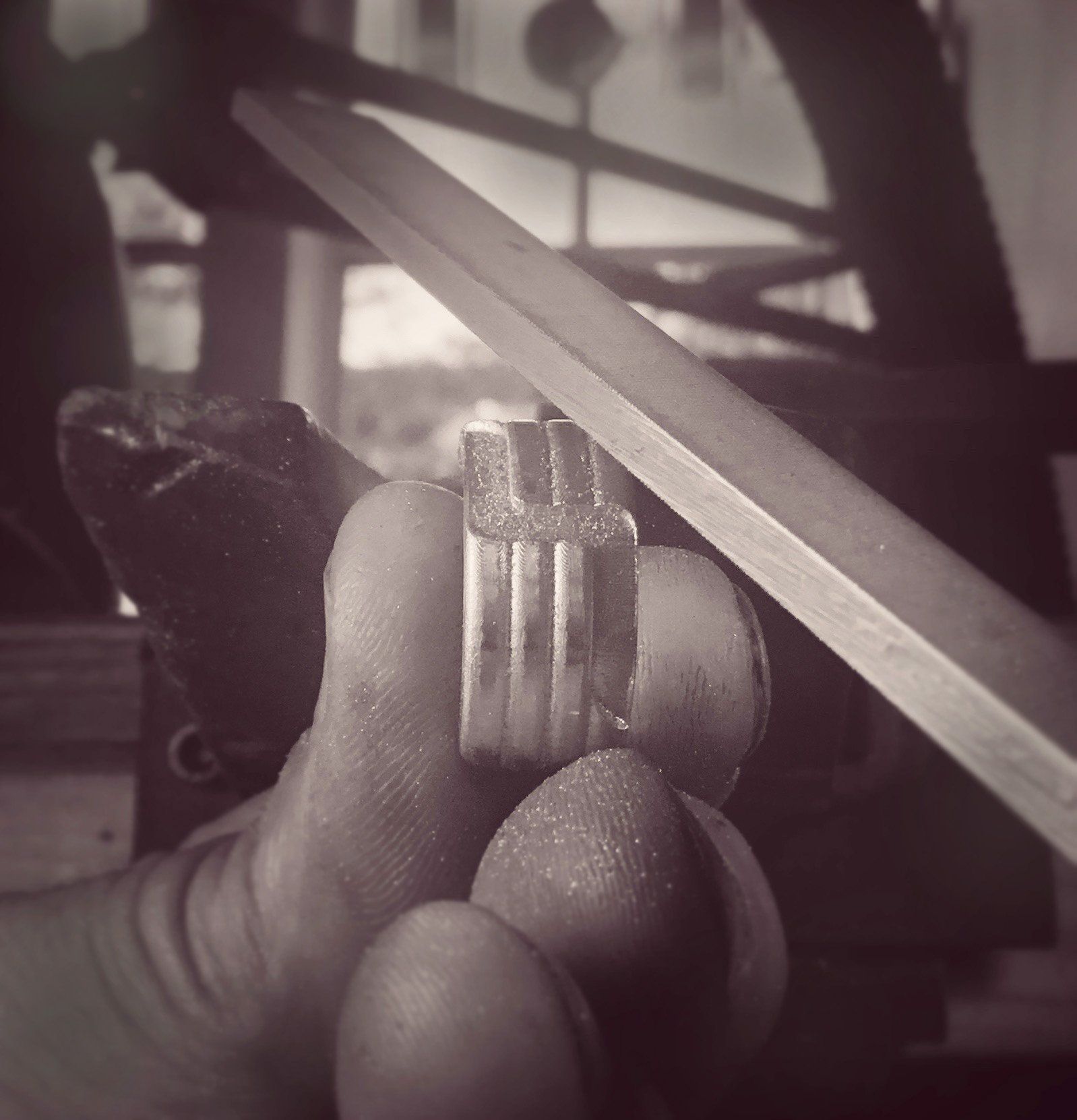 A black and white photo of a person holding a ring