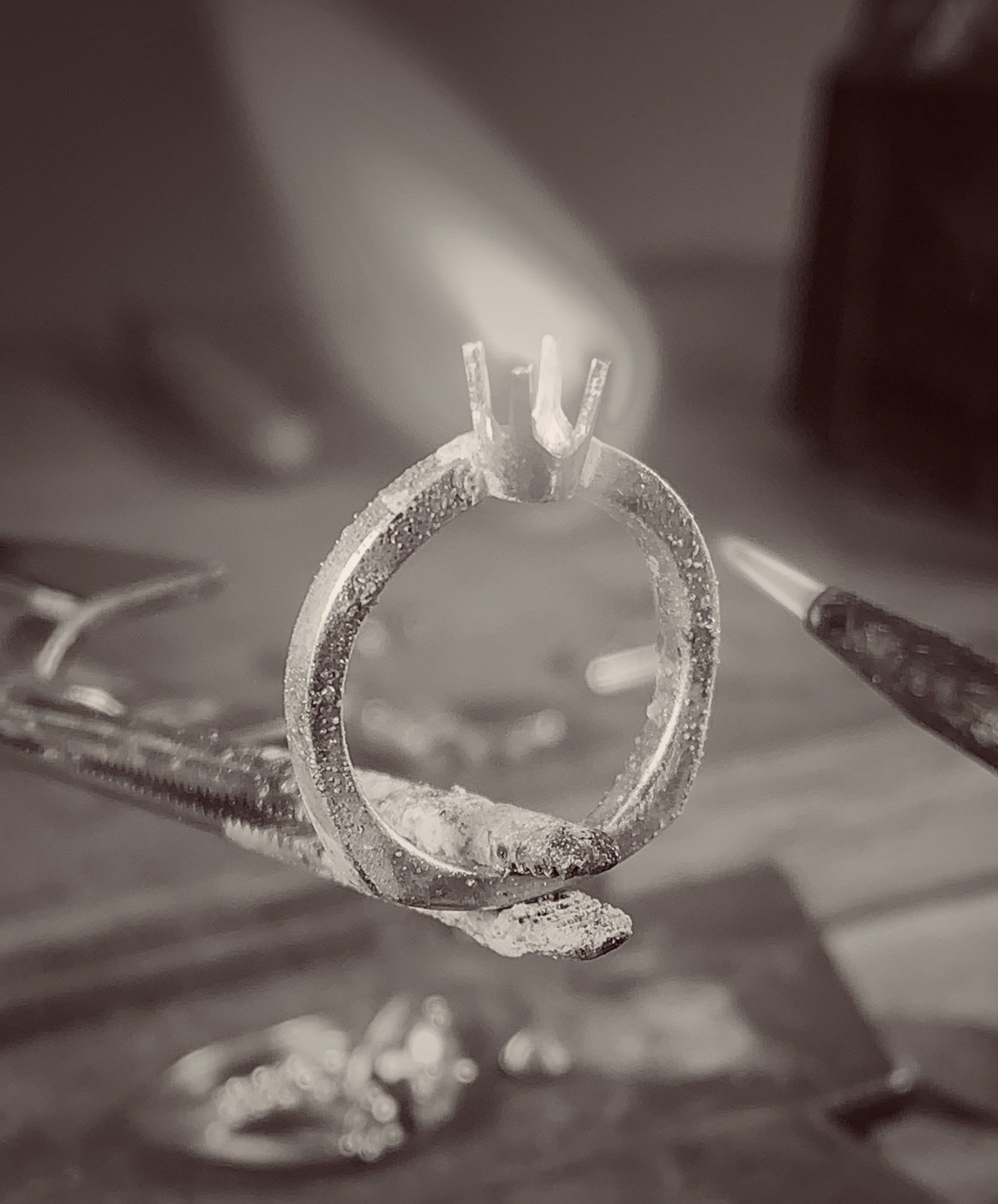 A black and white photo of a ring being made.