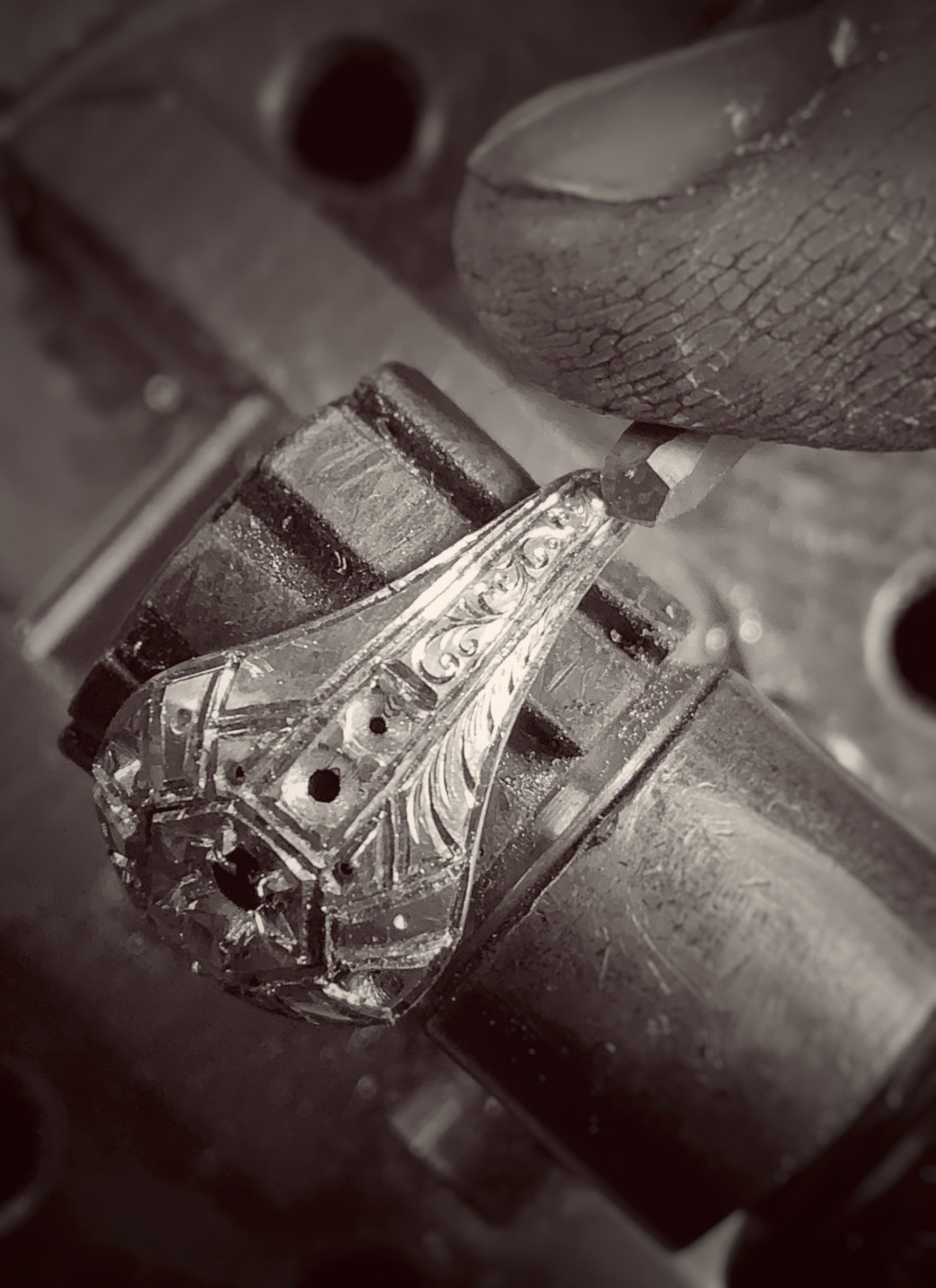 A black and white photo of a person holding a ring in their hand.