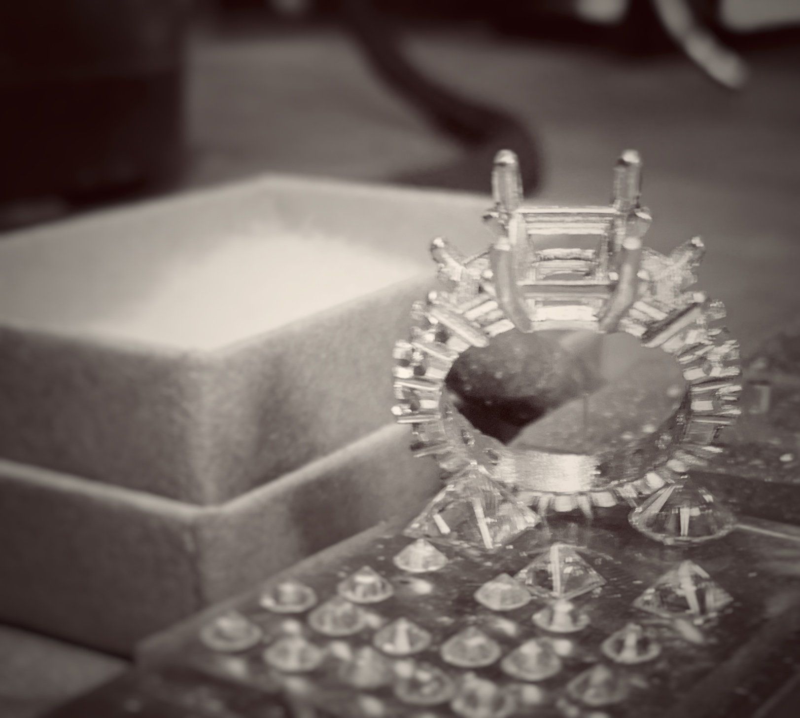 A black and white photo of a ring in a box
