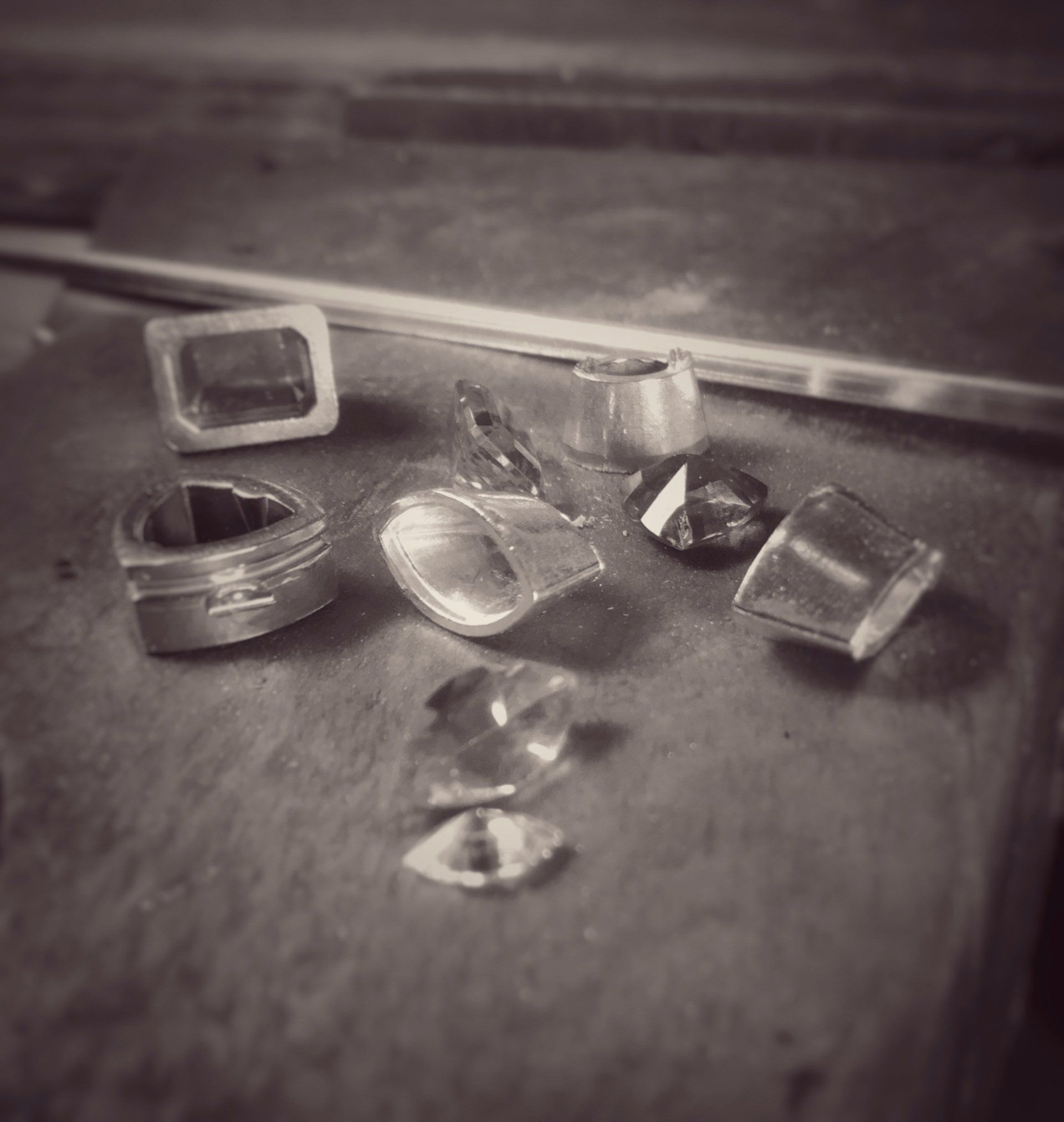 A black and white photo of a bunch of rings on a table