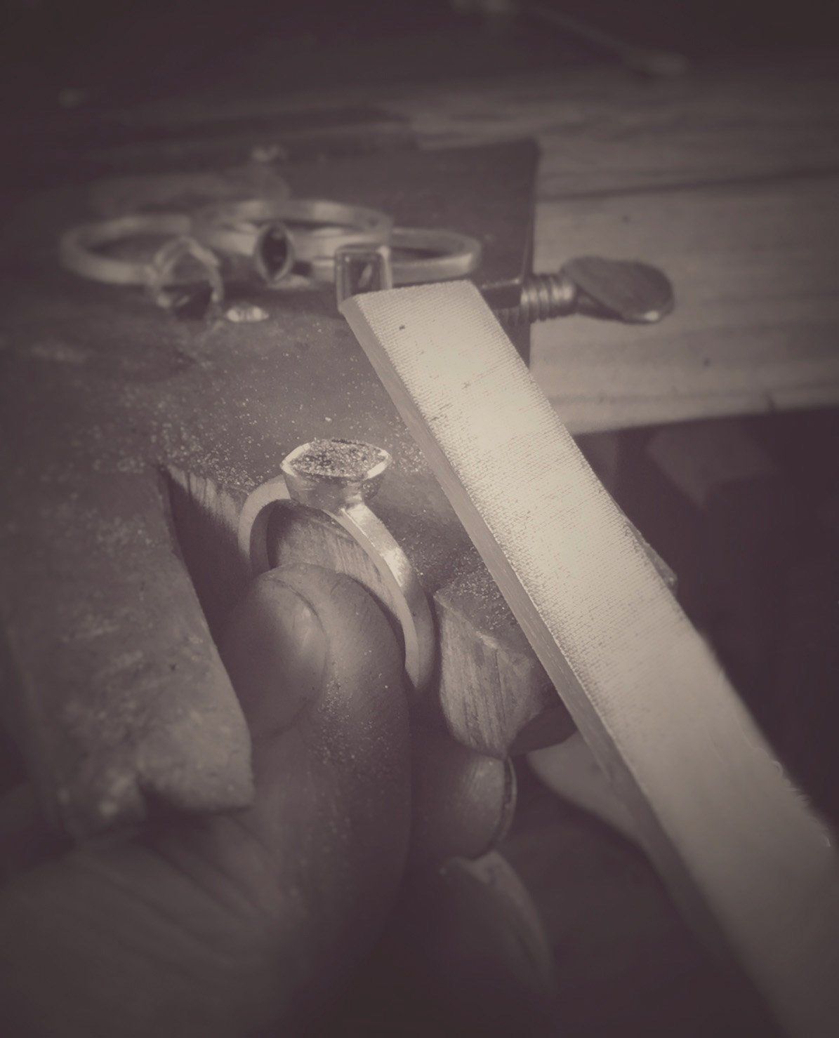 A black and white photo of a person making a ring.