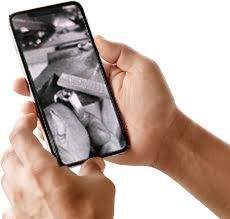A person is holding a cell phone in their hands.