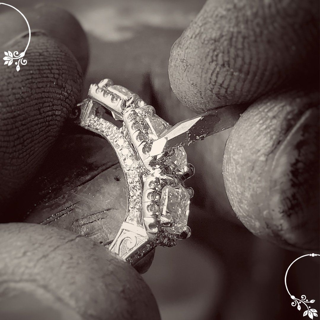 A black and white photo of a person working on a diamond ring