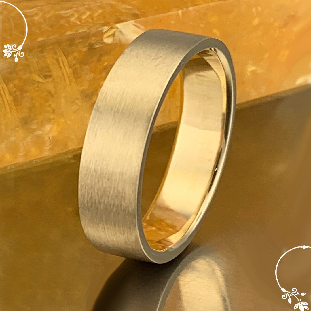A close up of a gold ring on a table