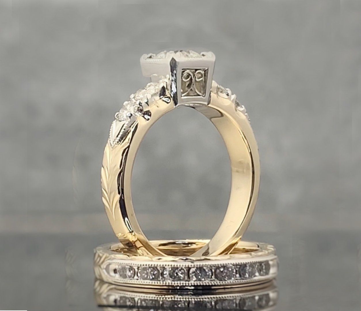 A pair of wedding rings are sitting on a table