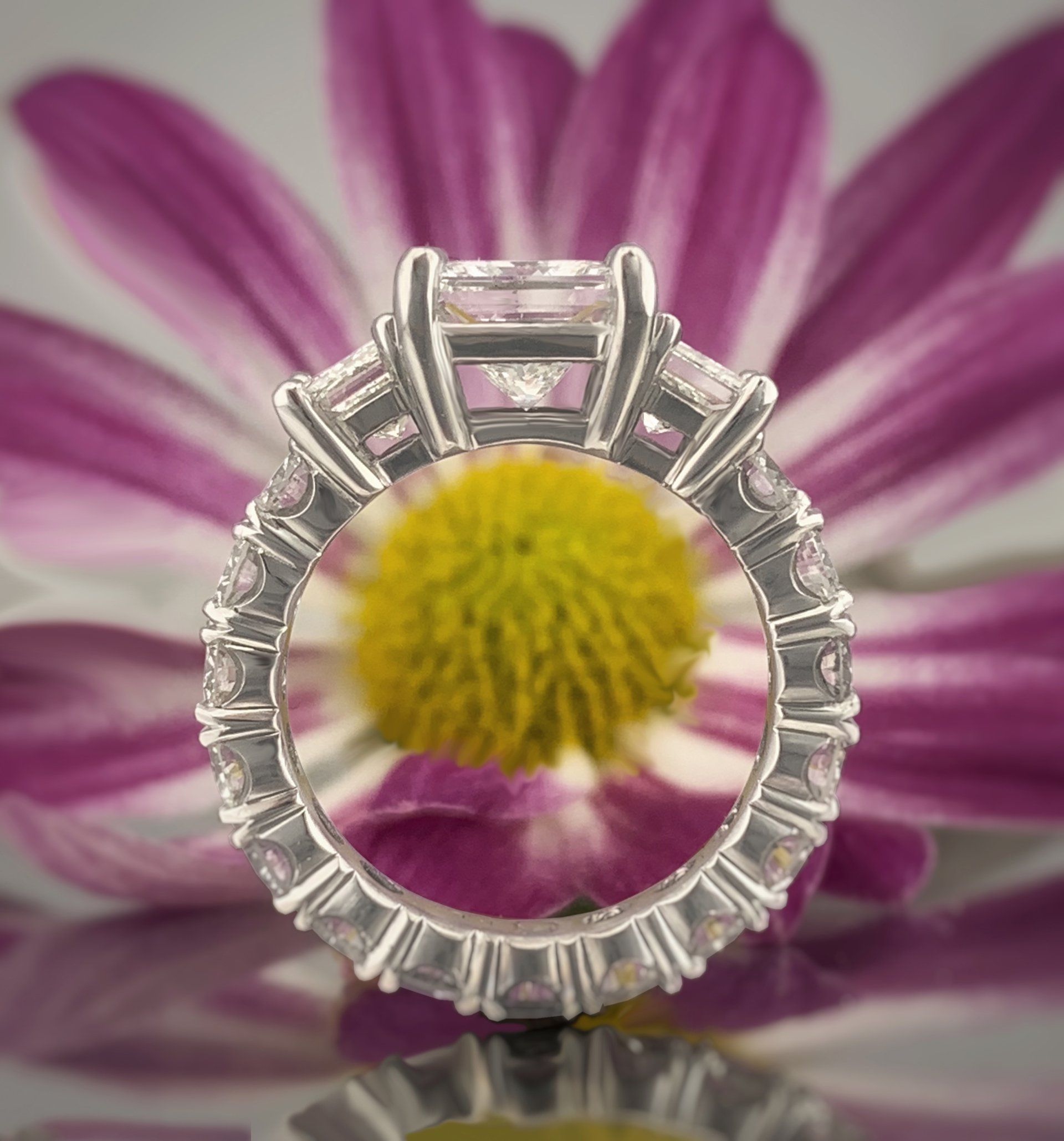 A ring with a purple flower in the background