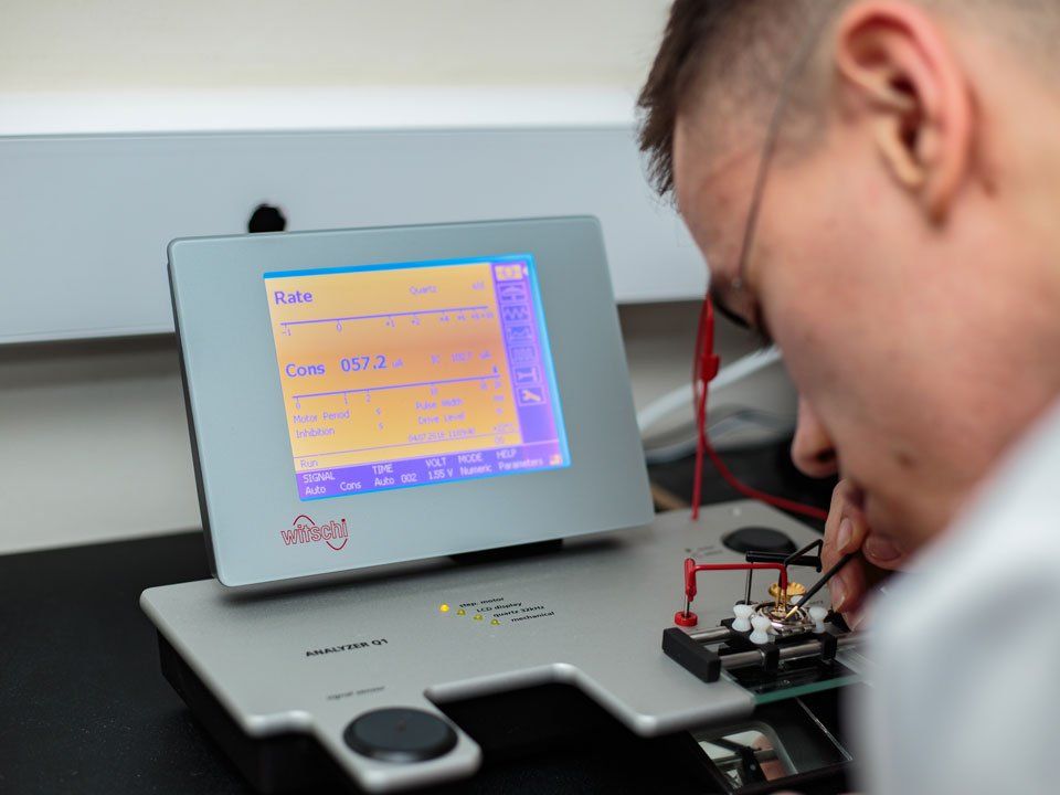 man using machine to check the parts of a watch