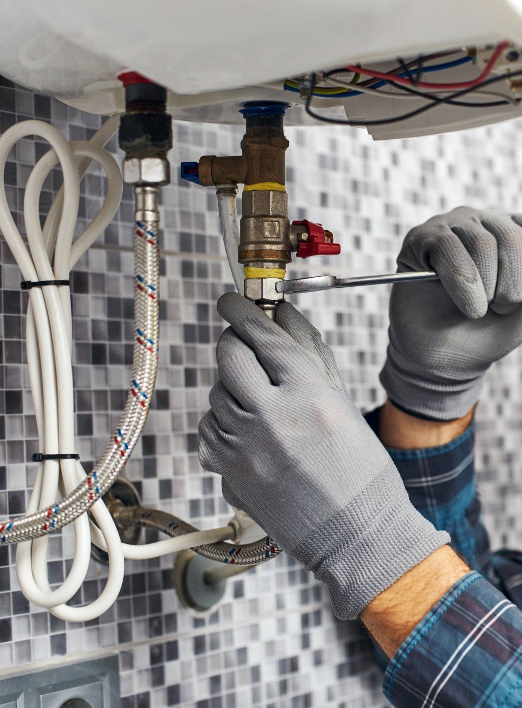 Commercial Plumber — Plumber Fixing the Water Heater in Fredericksburg, VA