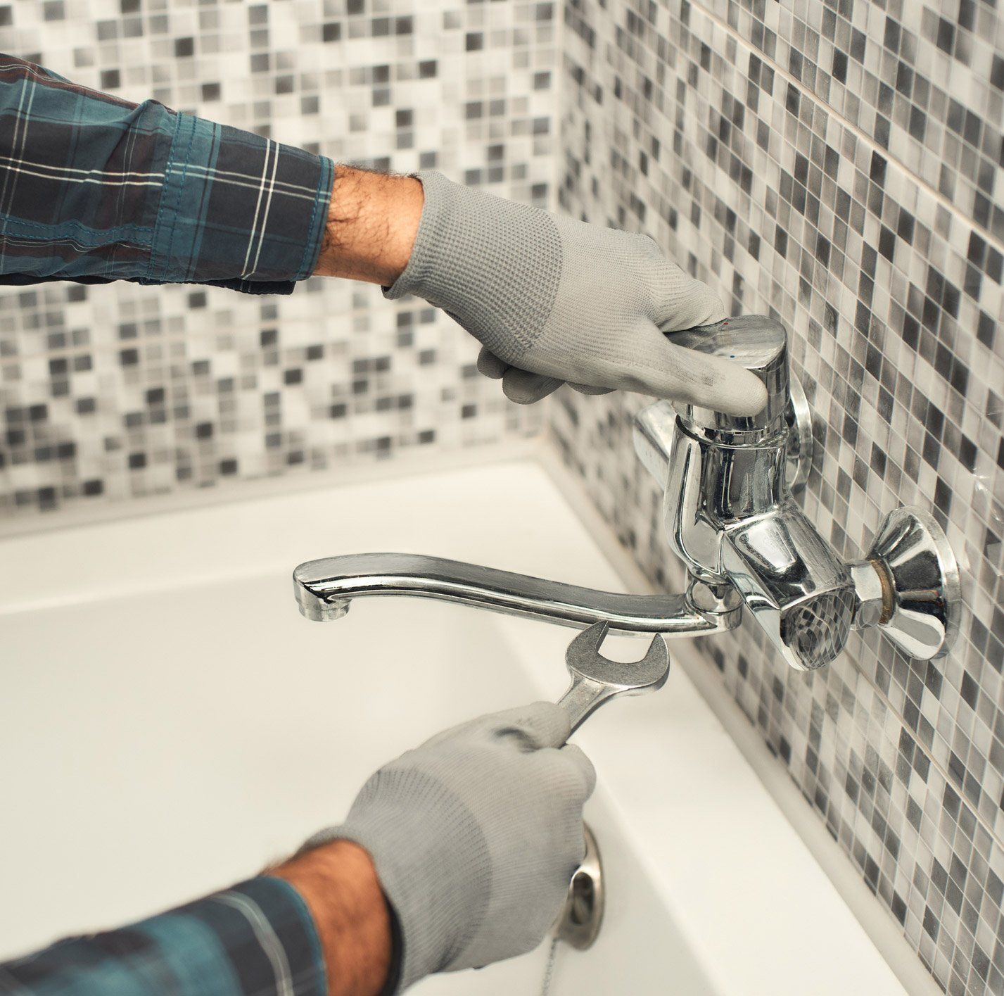 Bathroom Plumbing — Man Fixing the Faucet in Fredericksburg, VA Bathroom Plumbing — Man Fixing the Faucet in Fredericksburg, VA
