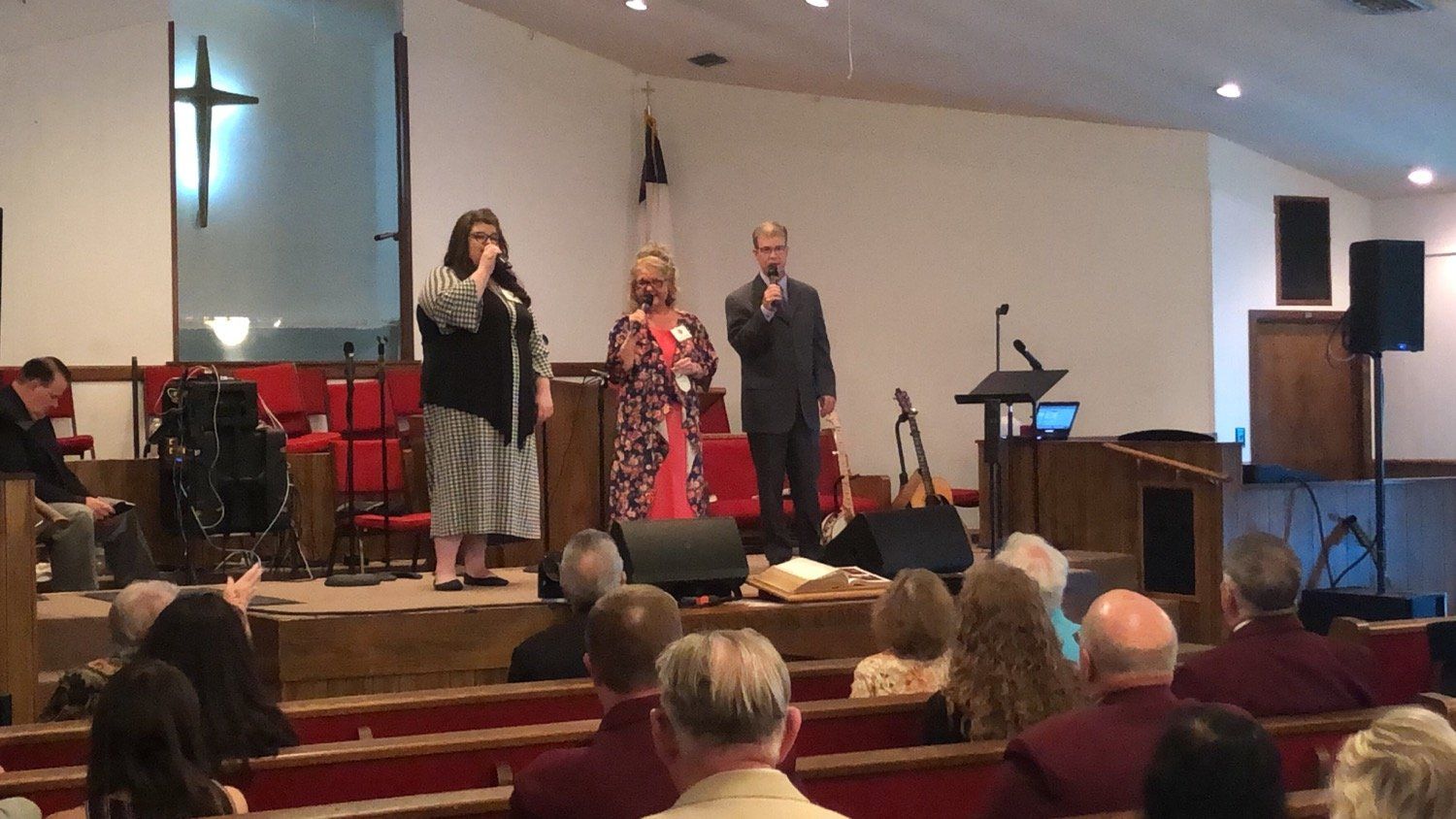 A group of people standing on a stage in a church