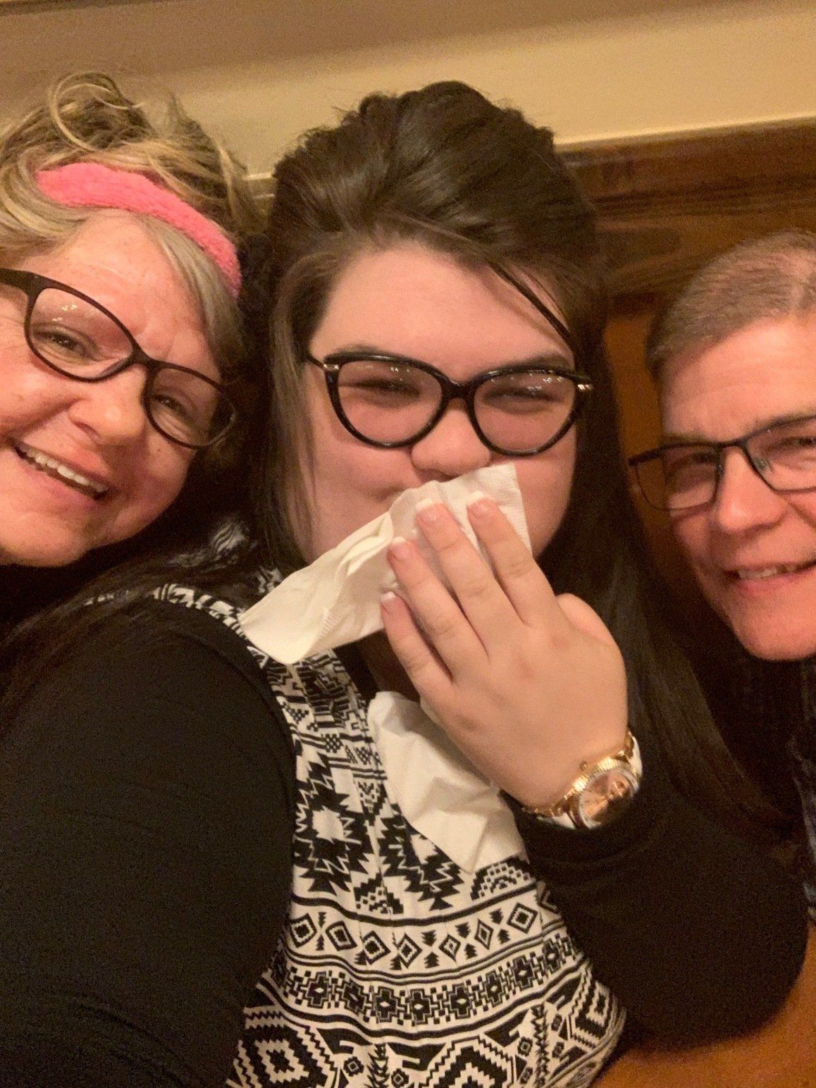 Three people wearing glasses are posing for a picture.