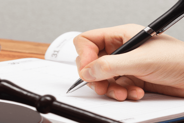 Lawyer writing in the diary