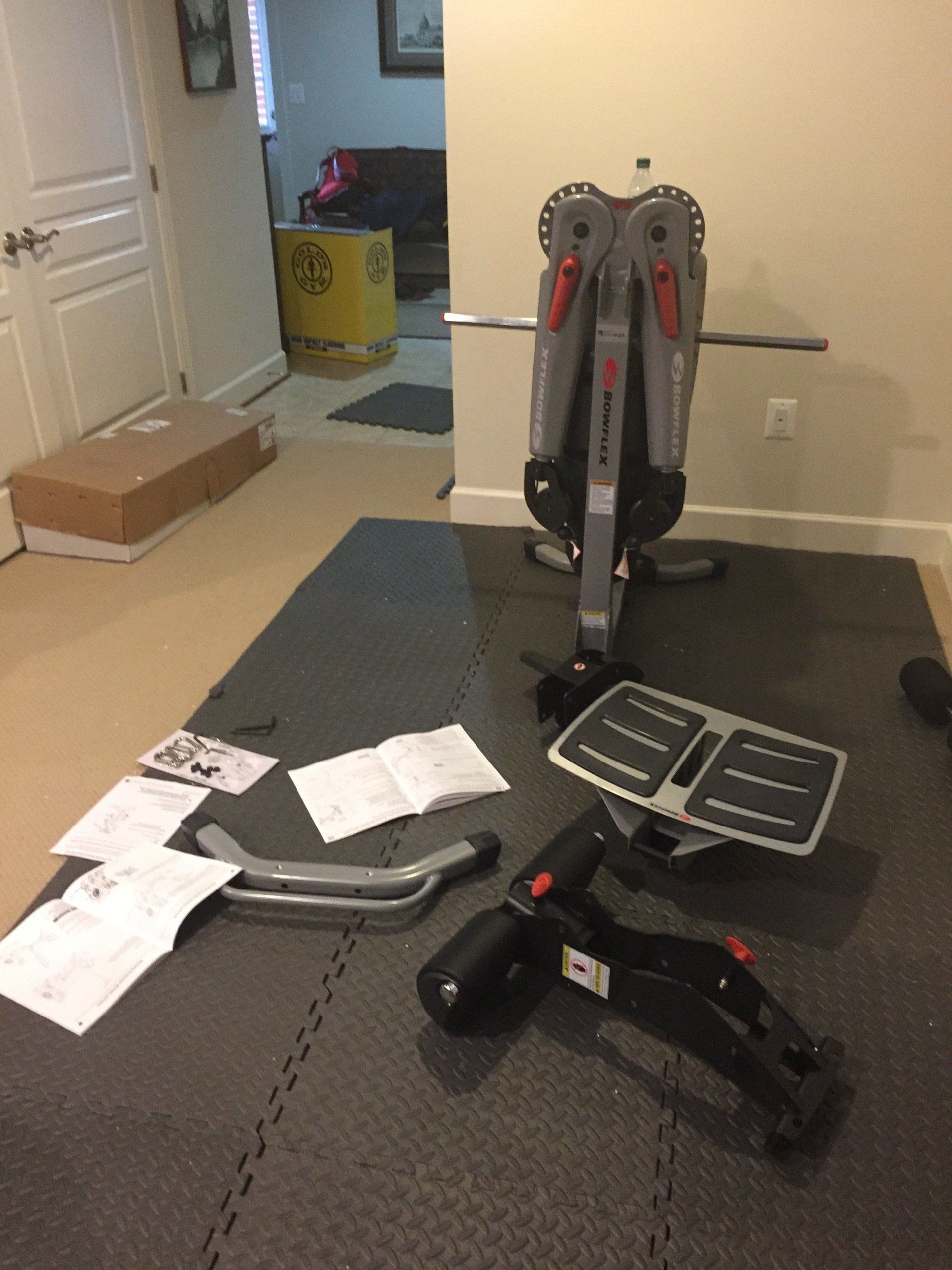 A gym equipment is sitting on a mat in a room