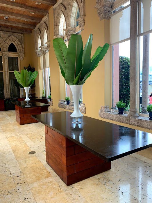 An office table with a plant in a vase on it