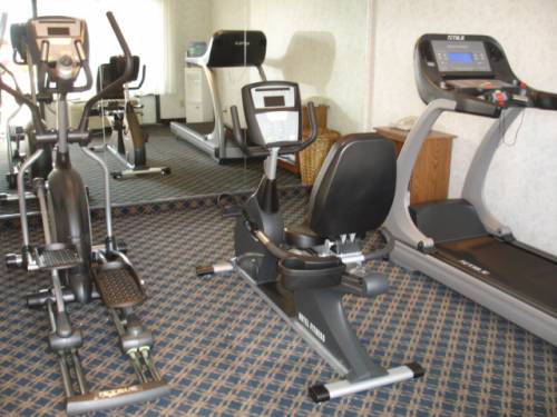 A gym with a treadmill and an elliptical