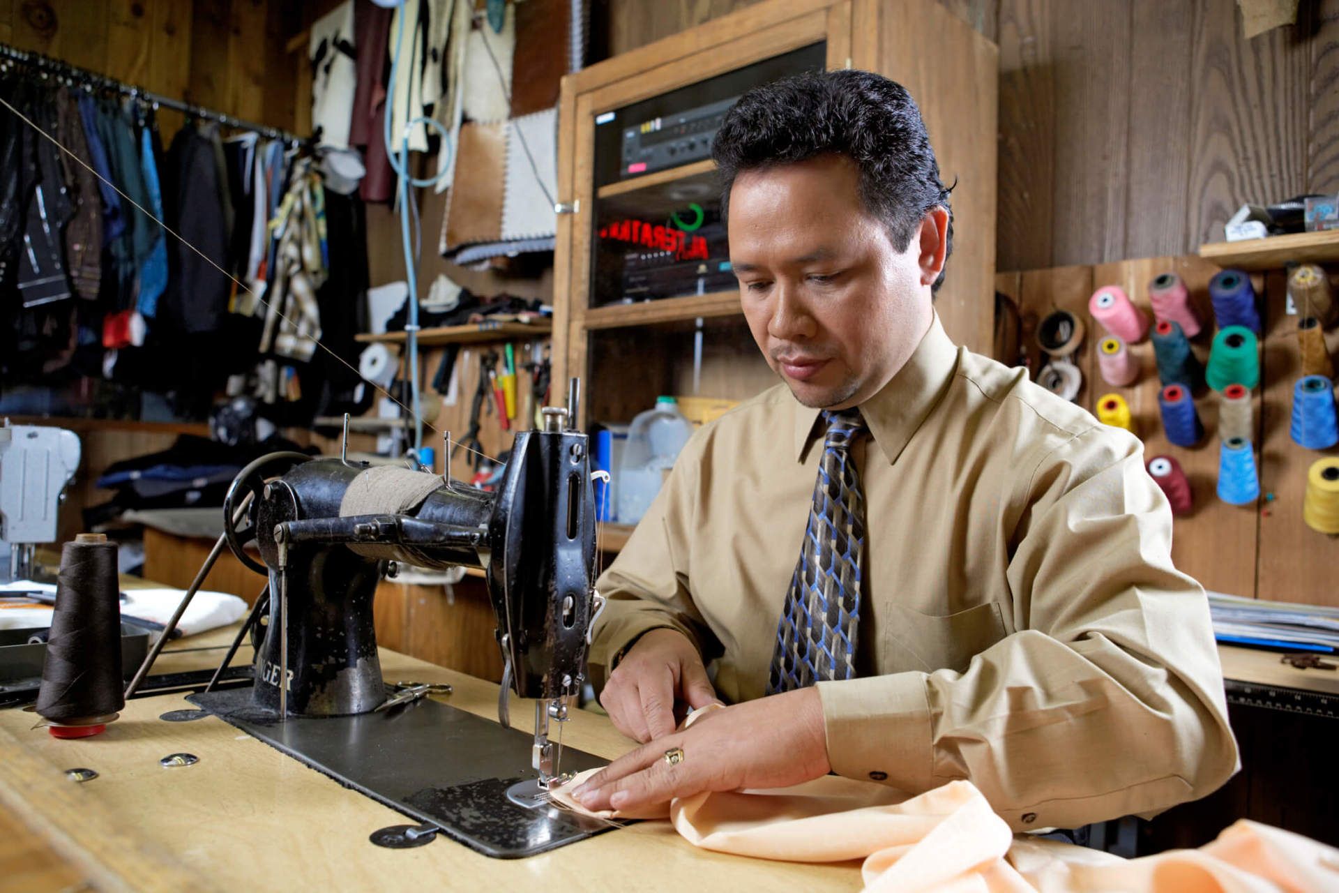 Man using sewing machine - Sewing service in Nashua, NH Man using sewing machine - Sewing service in Nashua, NH