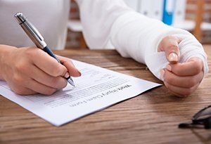 Workers' Compensation — Injured Worker Filling Up Form in Mt. Pleasant, SC