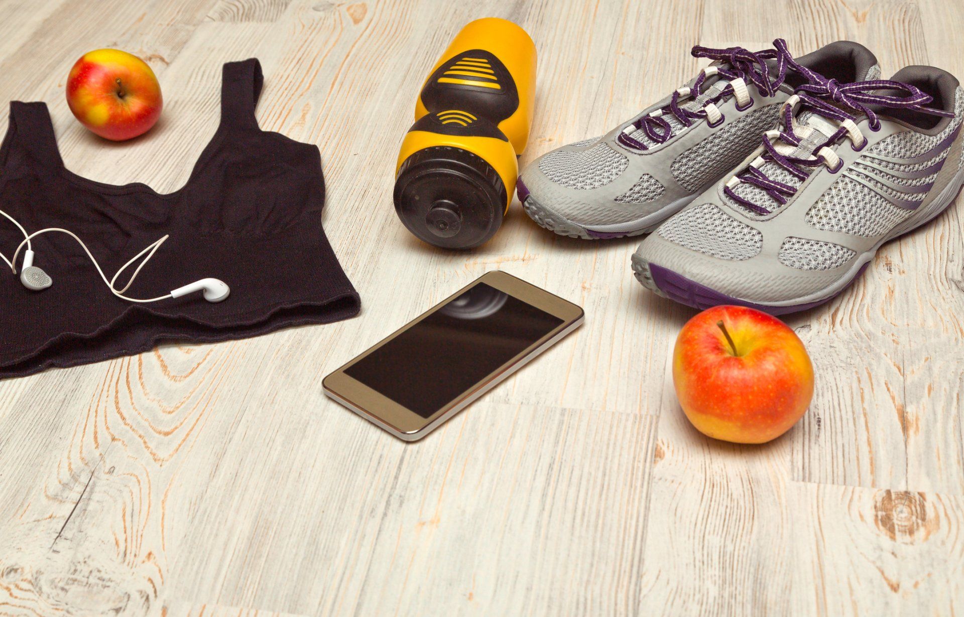 Sport shoes and water bottle with sports equipment