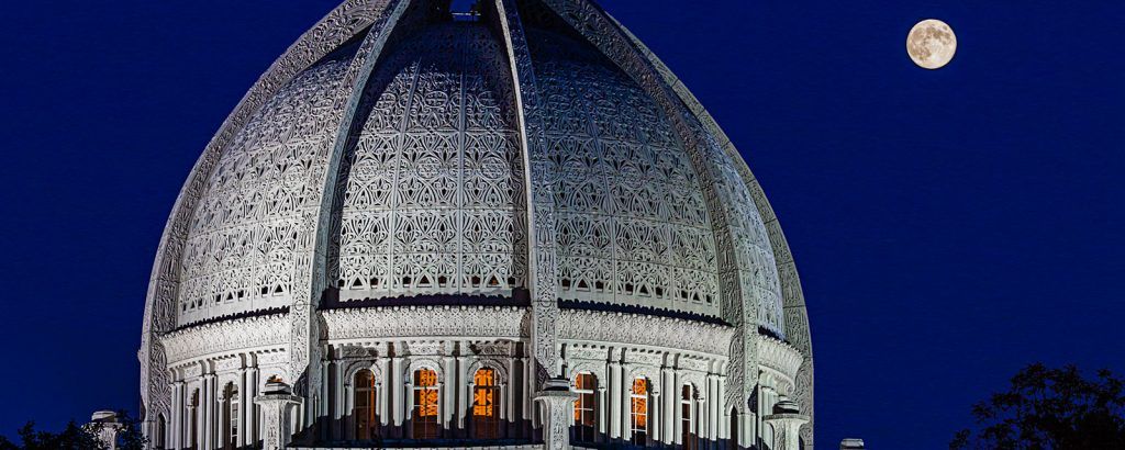 A dome shaped building with a full moon in the background