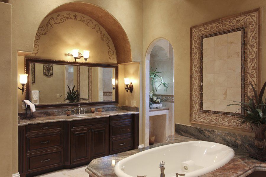 Dark stained wood vanity cabinets in immaculate arched opening for master bathroom remodeling project.