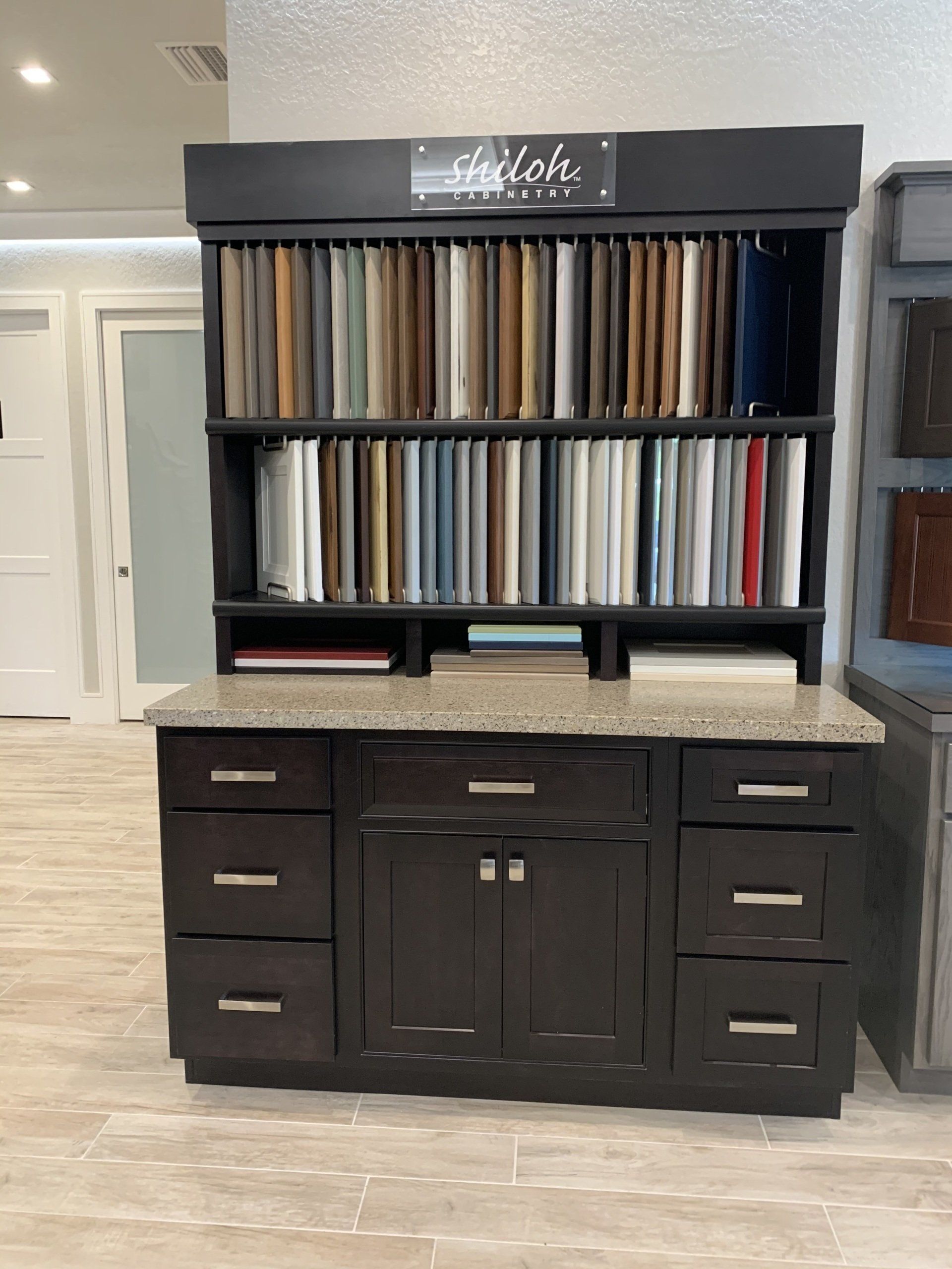 Just Counters showroom Shiloh cabinetry display. Door samples from WW Wood of