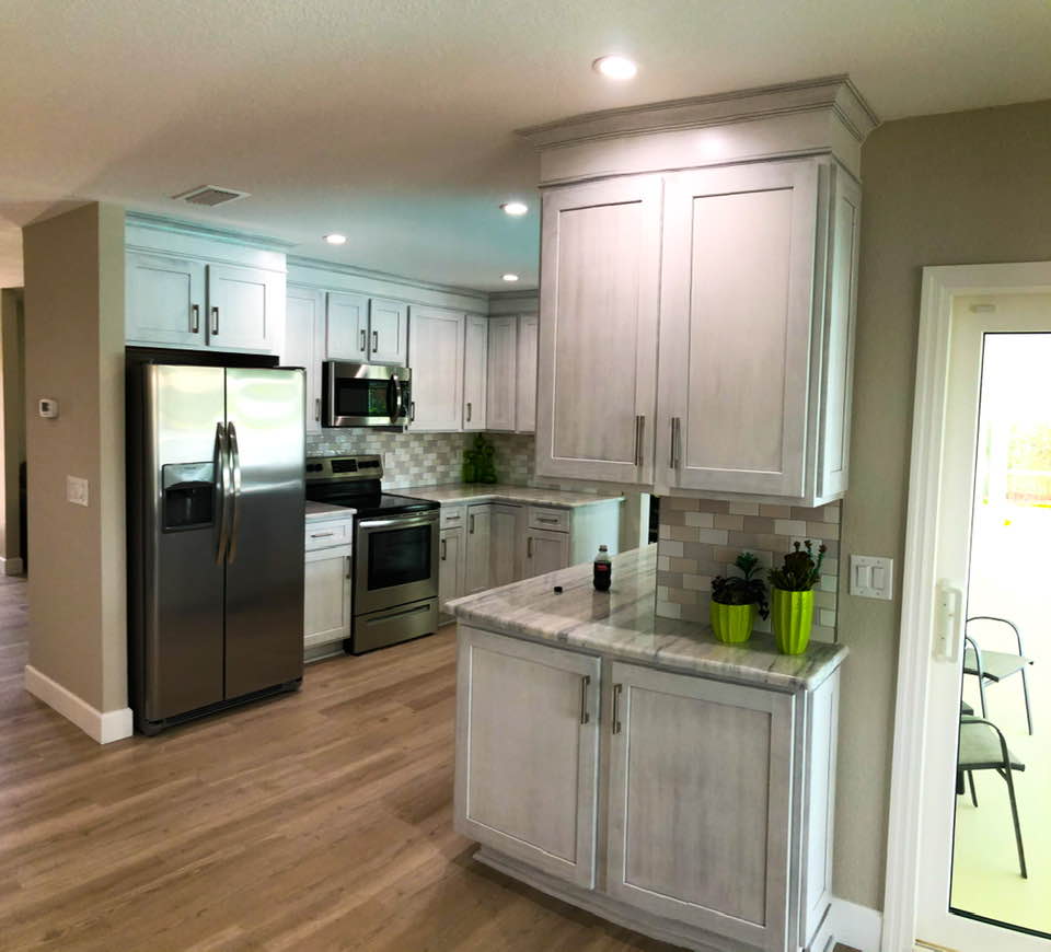 Subway tile backsplash with whitewashed stained shaker cabinetry. Kitchen remodel with crown to ceiling.