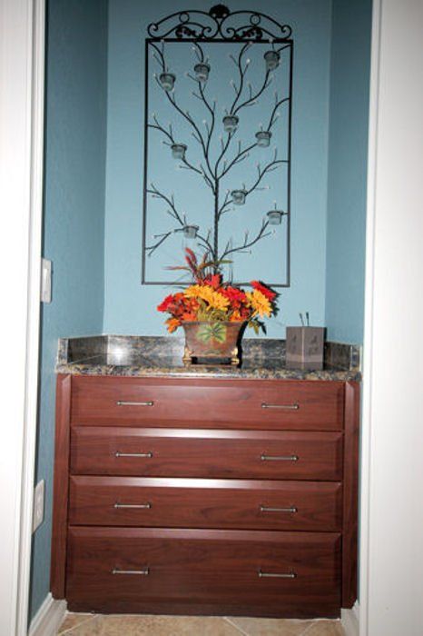 Built-in drop zone area remodel with beveled slab drawers and creative wall decoration.