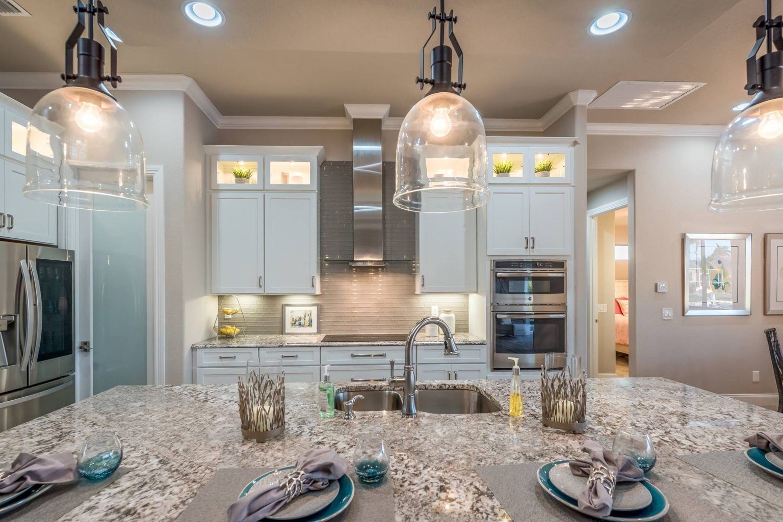 White shaker cabinets with stacked uppers.  Stainless hood and glass doors on wall cabinets.